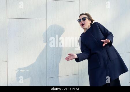 Portrait of a woman with bulging eyes, a short haircut and in sunglasses Stock Photo