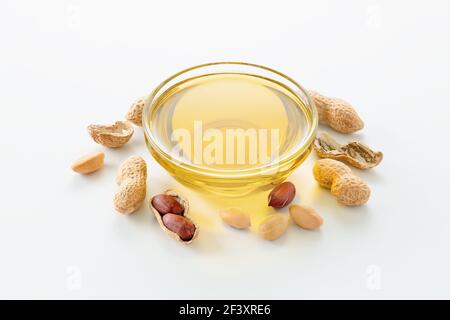 Natural peanut oil in a bowl with peanuts Stock Photo