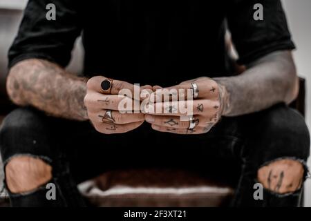 Close up of professional tattooer artist. Tattoo art on body. Equipment for making tattoo art. Master makes tattooed in studio. Stock Photo