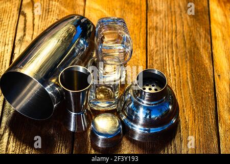 The bar utensils, drink concept. Cocktail shaker accessories on a wooden board. Stock Photo