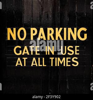 London UK, March 18 2021, No Parking Sign Painted On Black Security Gates With No People Stock Photo