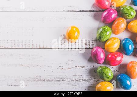 Easter wooden background with coloured eggs. Stock Photo