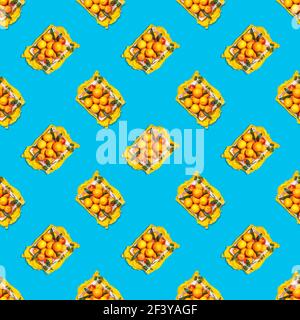 Seamless pattern of fresh, ripe oranges with leaves in a white box on a blue background. Composition for sale of healthy season fruits. Background wit Stock Photo