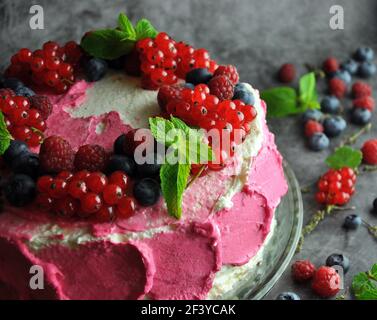 Berry cake with cream and mint lying. Close-up Stock Photo
