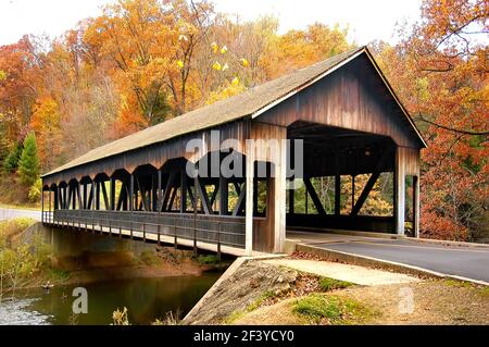 Fall colors with a wooden bridge at Mohican State Park in northern Ohio OH Stock Photo