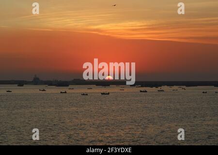 A dramatic and moody view of small boats in the sea against a blurred background Stock Photo