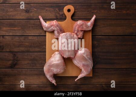 fresh red whole rabbit meat on a wooden cutting board, copy space Stock Photo