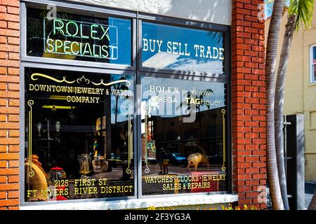 Fort Myers, USA - April 29, 2018: Florida Gulf of mexico coast city street with rolex watch clock repair specialist jewelry company shop store sign in Stock Photo