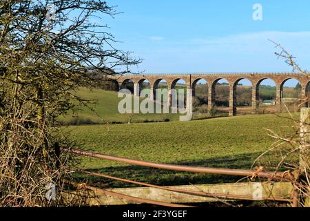 View looking towards the Ayr to Dalmelington railway viaduct near the village of Dalrymple on a March afternoon. Stock Photo