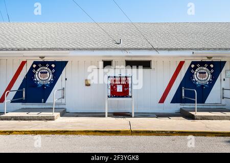 Naples, USA - April 30, 2018: US Coast guard auxiliary building sign for coastal guard patrol with boating courses board in Florida gulf of mexico cit Stock Photo