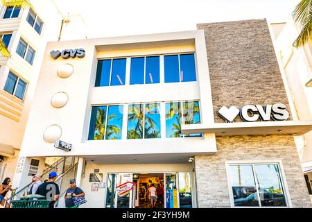 Miami Beach, USA - May 5, 2018: Looking up view of Art Deco district CVS pharmacy drugstore on South Beach Ocean drive street in Florida with people b Stock Photo