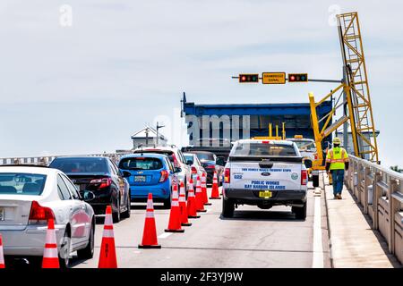 Bal Harbour, USA - May 8, 2018: Miami, Florida with Biscayne Bay Intracoastal water drawbridge on Broad Causeway with cars in traffic by stoplight Stock Photo