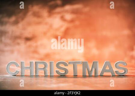 Word Christmas made of white concrete letters on neon light background. Copy space for your creative design. Festive invitation, greeting card Stock Photo