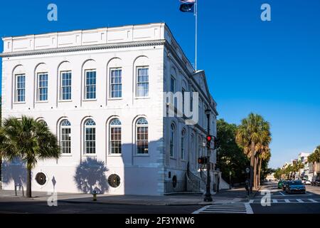 Charleston, USA - May 12, 2018: Southern Downtown old town French quarter by city hall building with American and state flags in South Carolina Stock Photo