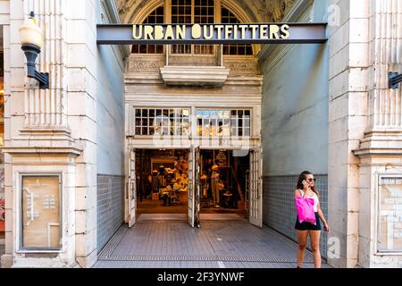 Charleston, USA - May 12, 2018: Urban outfitters clothes store shop sign with people woman talking on phone at French quarter old town on King street Stock Photo