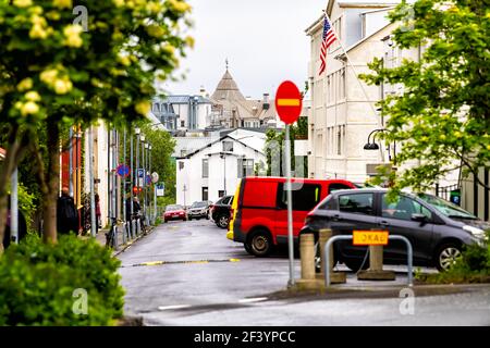 Reykjavik, Iceland - June 19, 2018: Quiet alley street road in downtown center and houses buildings with parked cars and stop sign Stock Photo