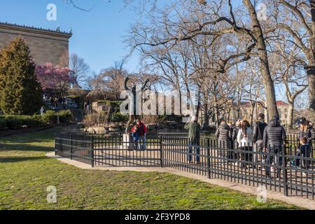 People queueing to have their photograph taken with the statue of Rocky Balboa next to the Philadelphia Museum of Art Philadelphia Pennsylvania. Stock Photo
