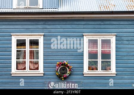 Reykjavik, Iceland - June 19, 2018: Gullkistan jewelry retail store in colorful turquoise residential wooden building with sign and wreath decorations Stock Photo