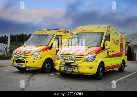 Two Mercedes-Benz ambulance vehicles parked outside a service station. Finland. Stock Photo