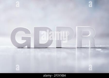 Word GDPR (General Data Protection Regulation) made with cement letters on grey marble background. Copy space Stock Photo