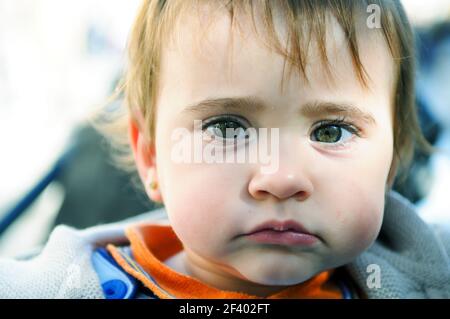 Close-up portrait of happy baby girl nine months old outdoors Stock Photo