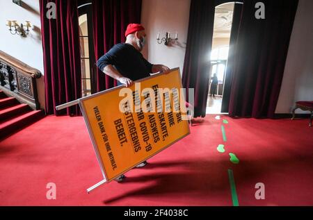 18 March 2021, Berlin: A sign about the hygiene concept and the procedures to be followed is put up in the foyer of the Berliner Ensemble. In a pilot project of the Berlin theatres to re-start in Corona times, a performance of "Panikherz" will be shown at the BE on Friday evening, where the audience had to be tested for the Corona virus in advance. Several institutions want to test how they might reopen. A total of nine events are planned until the beginning of April. Photo: Jens Kalaene/dpa-Zentralbild/dpa Stock Photo