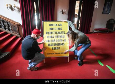 18 March 2021, Berlin: A sign about the hygiene concept and the procedures to be followed is put up in the foyer of the Berliner Ensemble. In a pilot project of the Berlin theatres to re-start in Corona times, a performance of "Panikherz" will be shown at the BE on Friday evening, where the audience had to be tested for the Corona virus in advance. Several institutions want to test how they could reopen. A total of nine events are planned until the beginning of April. Photo: Jens Kalaene/dpa-Zentralbild/dpa Stock Photo