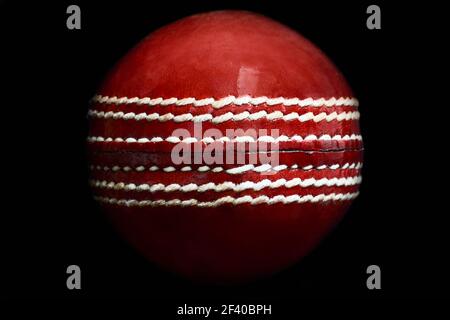 Close up of a leather cricket ball showing the seam Stock Photo