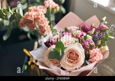 Nice and colorful bouqette of different flowers in flower shop. Close up. Stock Photo