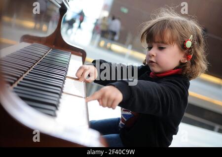 Adorable little girl having fun playing the piano Stock Photo