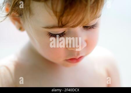 Close-up potrait of adorable little girl outdoors. Stock Photo