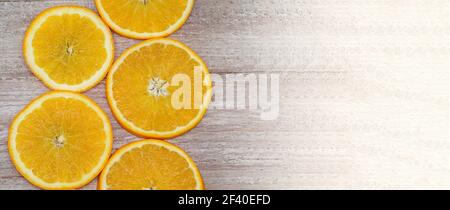 Oranges on a wooden background. Oranges cut into circles. Stock Photo