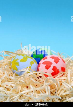 Close-up of colorful Easter eggs with children drawings. Handmade decorated Easter eggs. Above view. Selective focus. Vertical shot Stock Photo