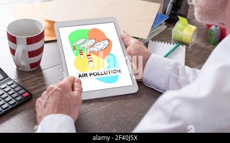 Air pollution concept shown on a tablet held by a man Stock Photo