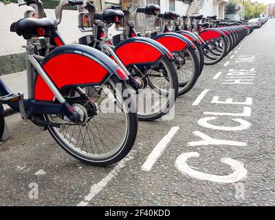 Bicycles for rent on The Docking Station in London, UK. Bicycles for rent at their station in London Stock Photo