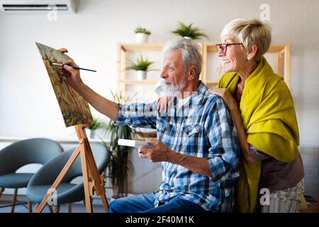 Loving senior couple relaxing at home. Mature husband and wife spending time together Stock Photo