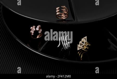 Four different types of golden rings on black display plates Stock Photo