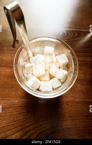 White Refined Sugar Cubes in the sugar-bowl top view on wooden background. Sugar in the bowl top view on wooden background Stock Photo