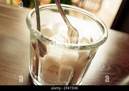 White Refined Sugar Cubes in the sugar-bowl angle view on wooden background. White Refined Sugar Cubes in the sugar-bowl angle view on table Stock Photo