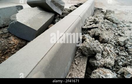 Concrete curb installation. Sidewalk pavement renewal. Road infrastructure repair.. Concrete curb installation. Sidewalk pavement renewal. Road repair. Stock Photo