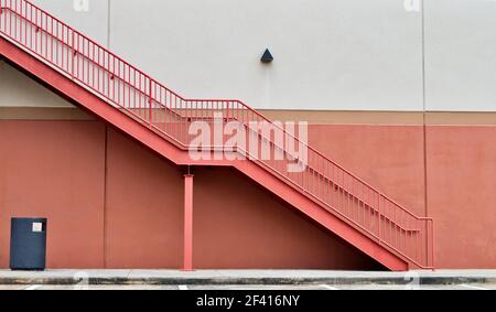 Generic pink stairs architecture on a wall. Minimalism image with pink and white wall background and copy space. Stock Photo