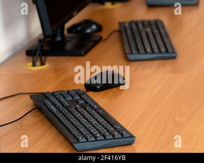 Empty computer class room tables with keyboards from above. Empty computer class room tables with keyboards Stock Photo