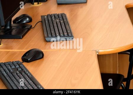 Empty computer class room tables with keyboards Stock Photo