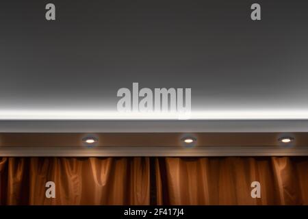 Copyspace on the celling framed by three lights and part of curtains Stock Photo