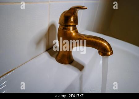 Bronze water tap in bathroom Stock Photo