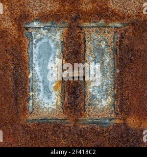 Remains of the letter H on rusty metal plate Stock Photo