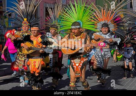 Folkloric Aztec musicians playing the mandolin and dancers performing in the city centre of Guanajuato, Central Mexico Stock Photo