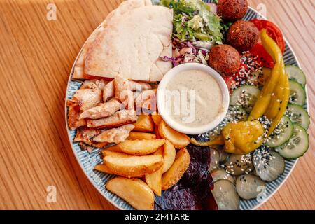 Traditional falafel balls with salad and hummus on a plate top view with a lot of copyspace. Traditional falafel balls with salad and hummus on a plate top view with copyspace Stock Photo