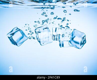 Ice cubes falling into the water sinking to the bottom. Abstract background. Stock Photo