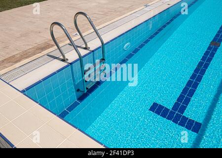 Grab bars ladder in the swimming pool Stock Photo
